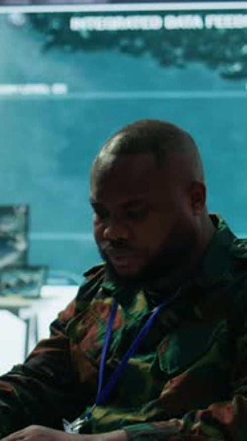 Man Typing on Laptop in Dark Tech Office