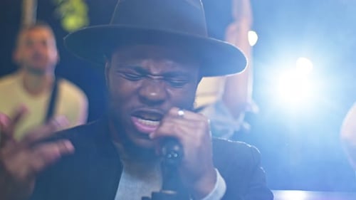 Close Up of Beautiful Young African American Man Singing Song on a Rooftop Party Friends Enjoying
