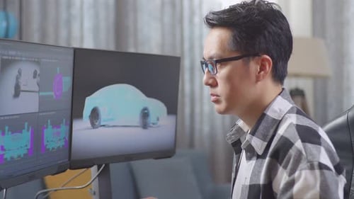 Man Designing Car on Computer in Home Office