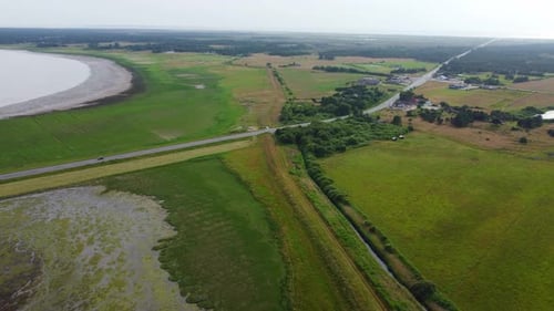 Drone shot road cutting through beautiful wild nature in Denmark