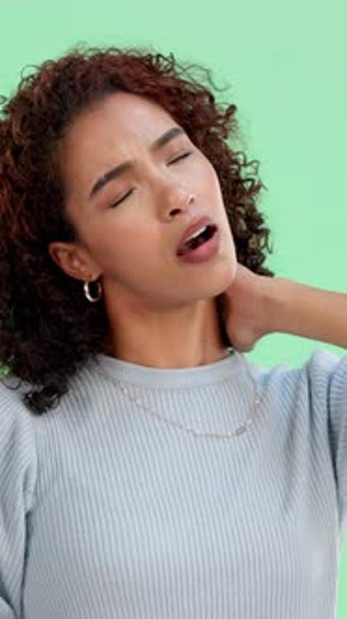 Injury, woman and massage neck pain on green screen, arthritis or spine accident in studio