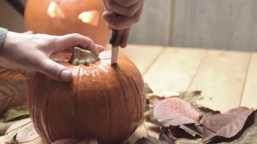 Carving Pumpkin with Knife for Halloween Decoration