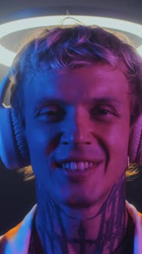 Blonde-haired Young Adult Smiling with Headphones On