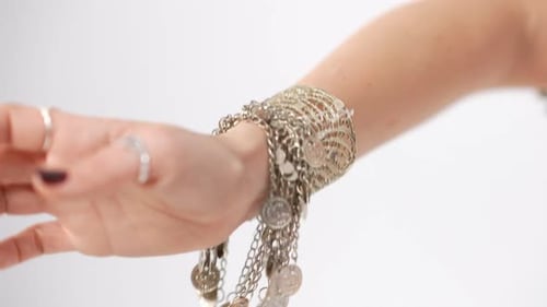 Closeup Tattooed Female Hand in Bracelet Moving in Slow Motion at White Background