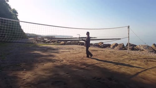 Businesswoman Walks to Sea at Old Abandoned Beach to Play Beach Volleyball Near Old Vintage Net in