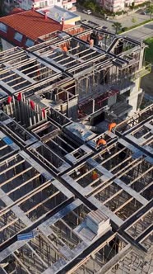 Vertical Video Drone Shot of Construction Site with Coastal Background