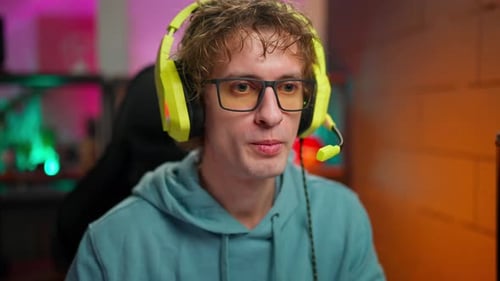 Young Adult with Headset Talking into Microphone