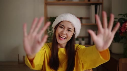 Young Woman Smiles and Reaches Towards Camera