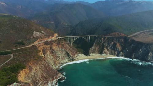 Bixby Bridge over Highway One at famous Big Sur in California with fog. Aerial
