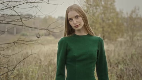 Model posing wearing green dress in autumn