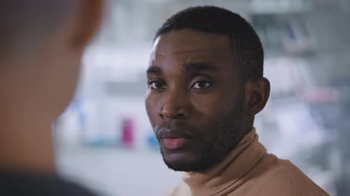 Man Listening to Colleague in Office Meeting