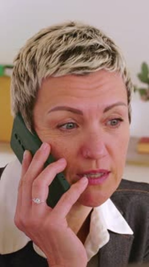 Middle Aged Businesswoman Talking on Phone in Office