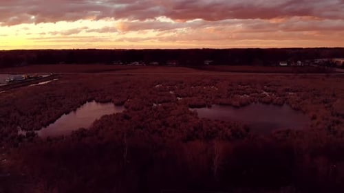 Aerial view of a marsh and clouds at sunset