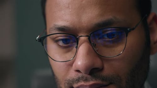 Close Up Concentrated Entrepreneur Work Online with Computer Data Male Eyes in Eyeglasses Looking