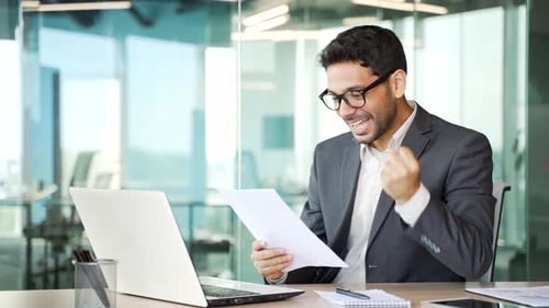 Successful Young Adult Celebrating Achievement in Modern Office