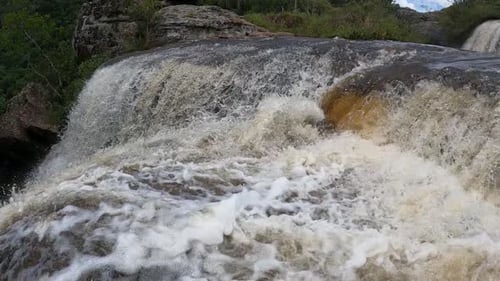 Strong movement of water in a waterfall with rapids, shot in slow motion