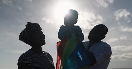 Happy African Parents Having Fun on the Beach with Their Son -