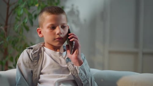 Boy Using a Phone Inside