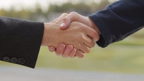 Close-Up of Men Shaking Hands – Faces Not Visible