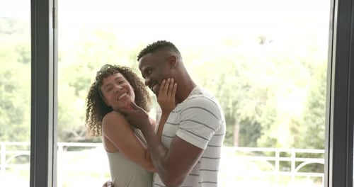 Romantic Couple Embracing and Smiling Indoors