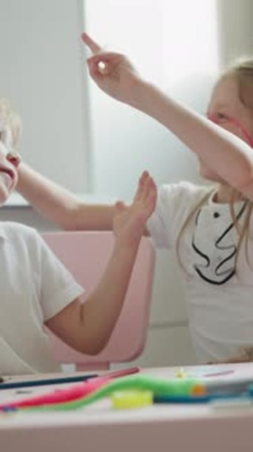 Children Play Together Drawing at Table Indoors