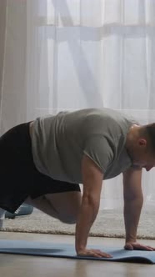 Focused Home Workout Sequence Showing a Man Performing Intense Core and Cardio Bodyweight Mountain