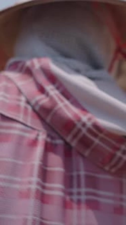 Young Vietnamese Man Raking Over Rice to Dry in Vietnam