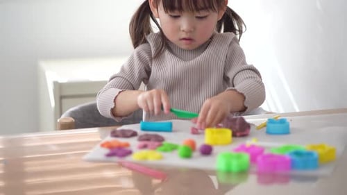girl playing with clay
