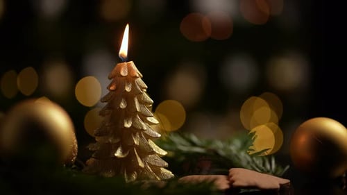 Christmas Tree Candle and Gold Ornaments Still Life