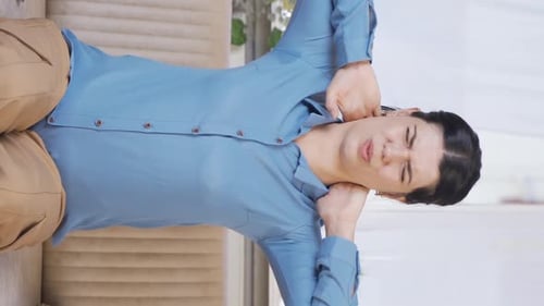 Woman Massaging Sore Neck at Home