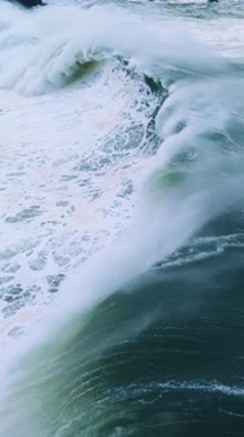 Ocean Wave Crashing with Force In Slow Motion The Emeraldgreen Water Contrasts with the Frothy White