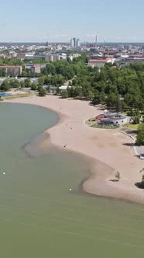 Vertical drone shot away from the Hietaniemi beach, sunny, summer day in Helsinki