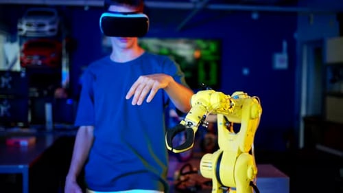 Young Adult Controls Robot with Virtual Reality