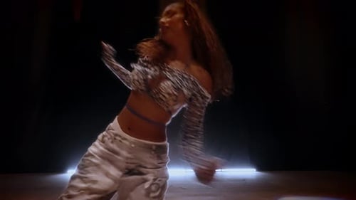 Energetic Hip Hop Dance By Woman Under Matrix Beam Lighting In Studio