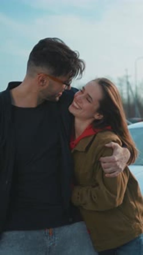 Smiling Couple Embracing Outdoors on a Sunny Day