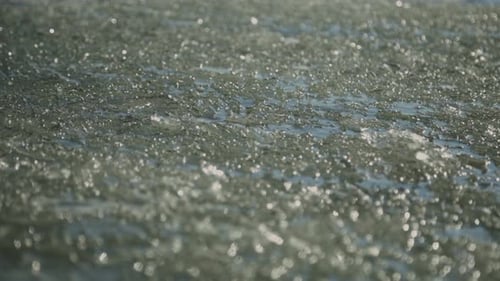 Wavy Water Surface With Broken Ice In Freezing River. - Close Up Shot