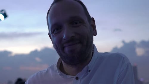 Portrait of Happy, Young Man Standing on Terrace in Bar 30s