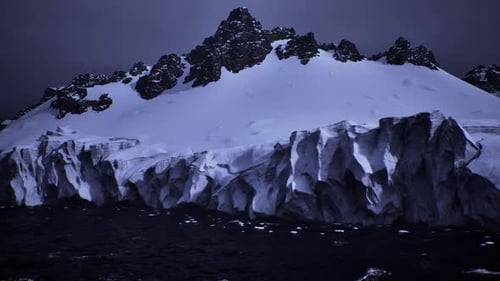 Aerial Flight Over Icy Glacier and Snowy Mountain Landscape