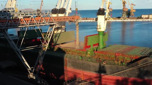Aerial of Wheat Loading to Bulker Ship Cargo Hold at Sea Grain Elevator in Sea Port Wheat Shipment