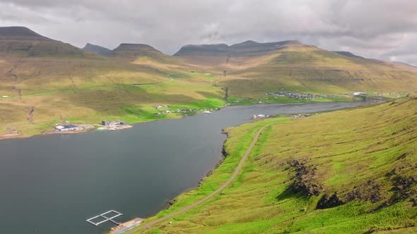 Majestic aerial shot of the Faroe Islands’ tranquil fjord with lush ...
