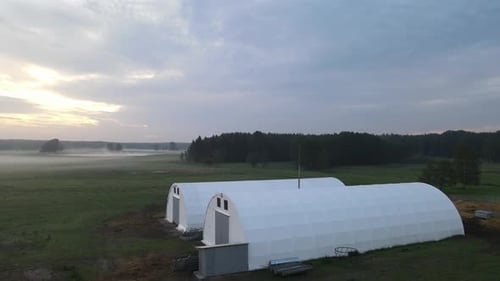 two white arched hall in dawn sunrise aerial circulating left