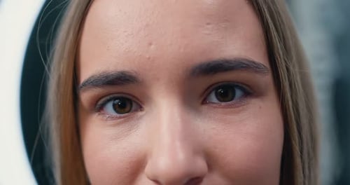 Close-up Portrait of Young, Beautiful and Natural Woman Opening Her Eyes. Girl Opens Her Eyes
