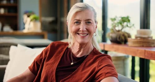 Laughing, face and woman in lounge, relax and comfortable on couch, chill and happy on break