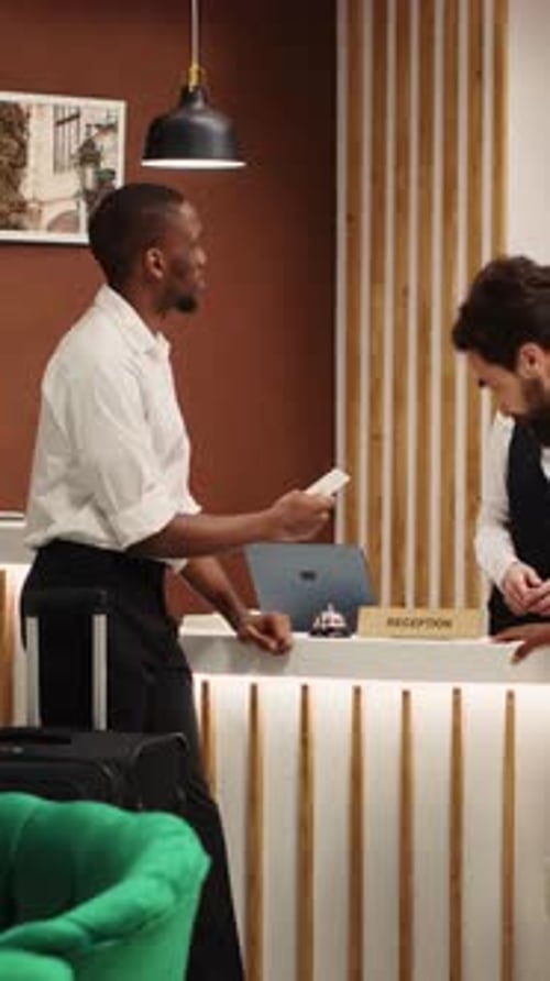 Vertical Video Newlywed Couple Checking in Posh Hotel