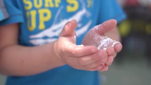 Cooking class. Children make the form of bread dough at school. View of hands in slow motion
