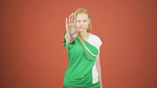 Woman making stop sign for camera.