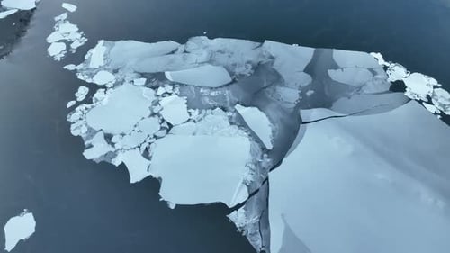 Wide aerial view of melting sea ice, snow, results of climate change