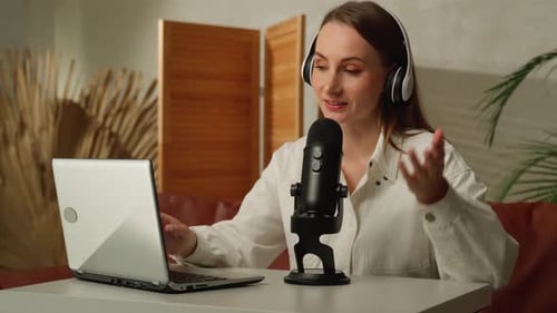 Woman Recording Podcast with Laptop and Microphone