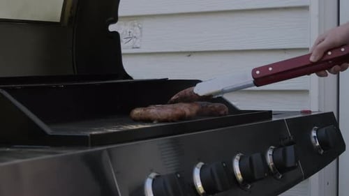 Slow Motion Shot of Grill Sausage on a Charcoal Barbecue Grill with a Fire