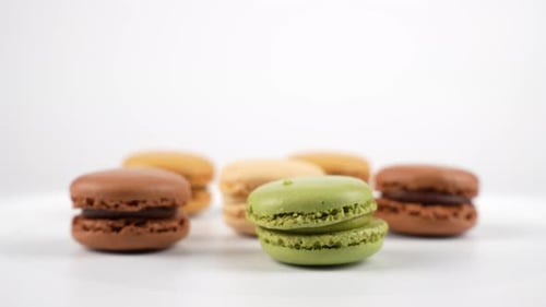 Colorful assortment of macarons displayed on white background